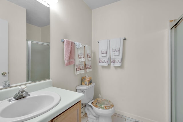 bathroom with vanity, tile patterned flooring, a shower with shower door, and toilet