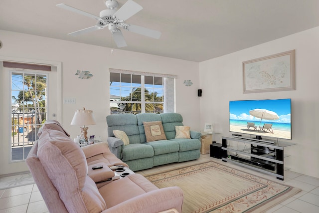 living room featuring a wealth of natural light, ceiling fan, and light tile patterned flooring