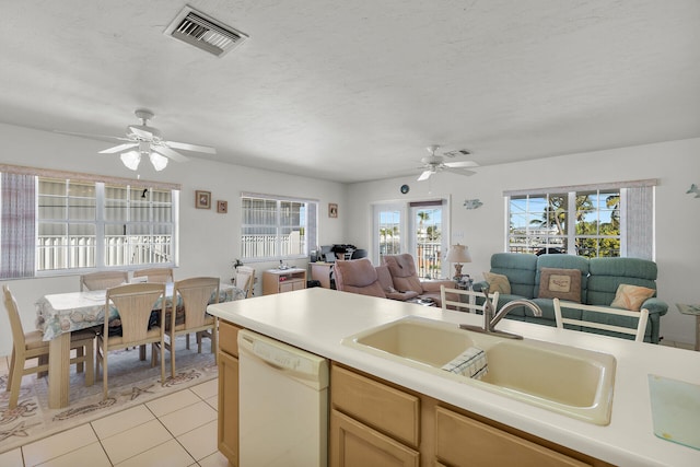 kitchen with sink, a textured ceiling, light tile patterned floors, white dishwasher, and ceiling fan