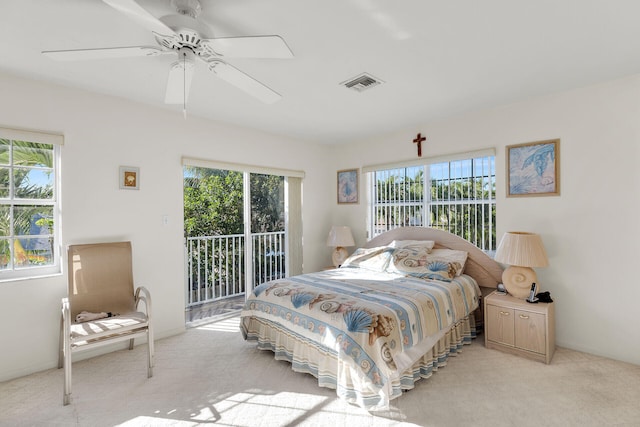 bedroom featuring multiple windows, light carpet, access to exterior, and ceiling fan