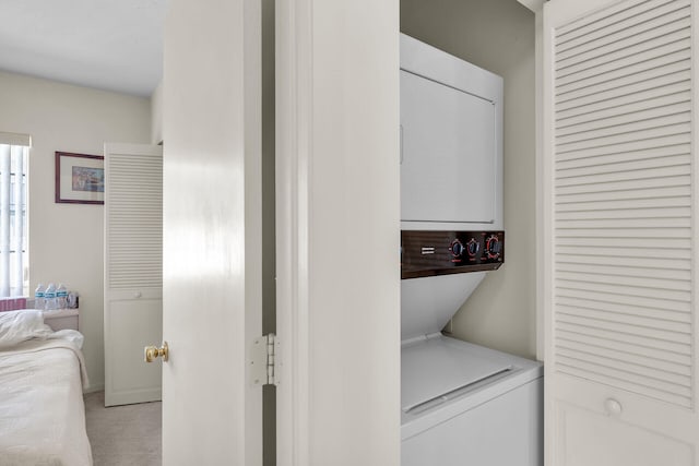 laundry area with stacked washer / drying machine