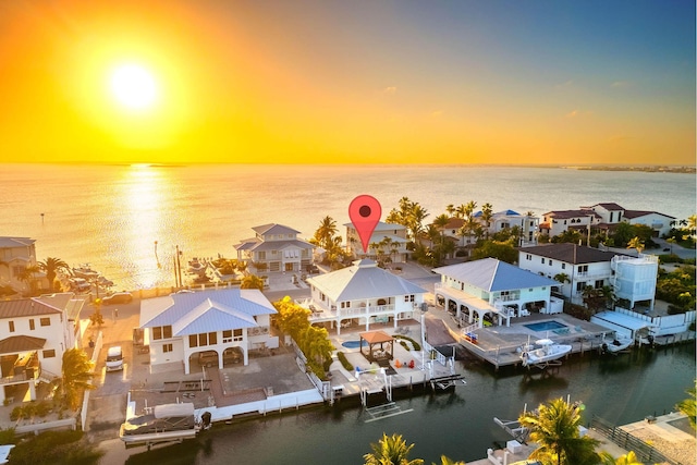 aerial view at dusk with a water view