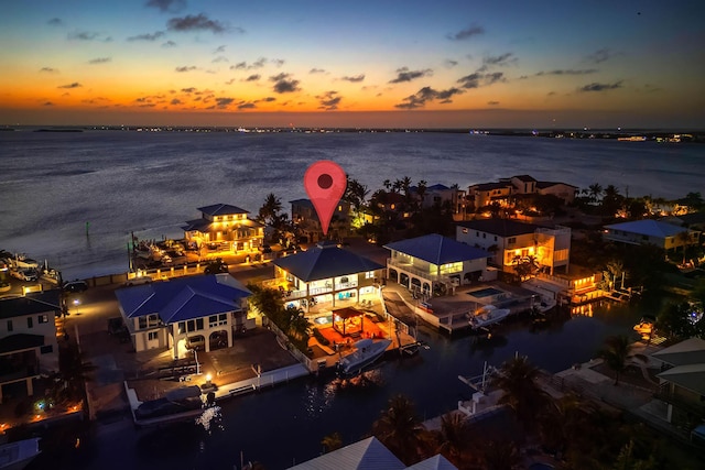 aerial view at dusk with a water view