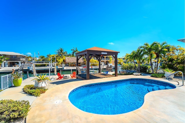 view of pool featuring a gazebo and a water view