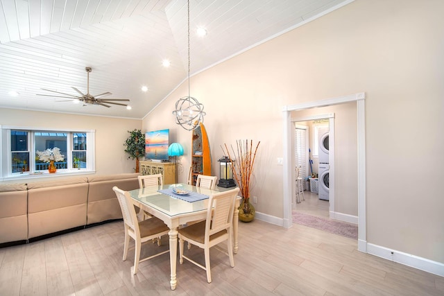 dining room with stacked washer and dryer, wood ceiling, ceiling fan, vaulted ceiling, and light wood-type flooring