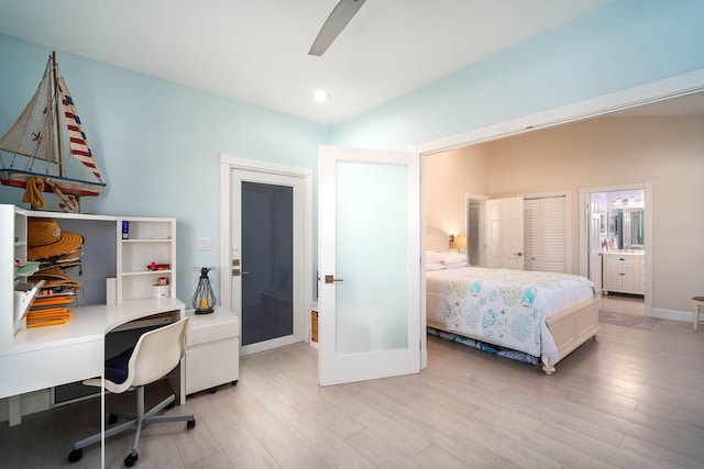 bedroom with ensuite bathroom, lofted ceiling, ceiling fan, and light hardwood / wood-style floors