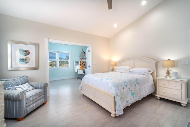 bedroom featuring lofted ceiling, light hardwood / wood-style flooring, and ceiling fan