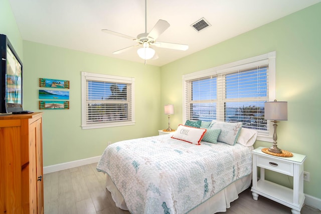 bedroom with light hardwood / wood-style flooring and ceiling fan