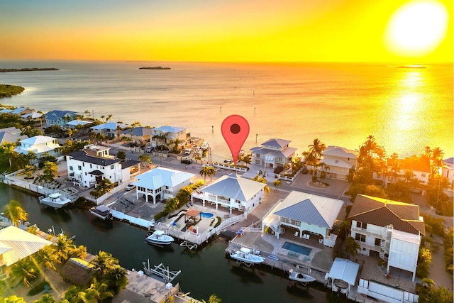 aerial view at dusk with a water view