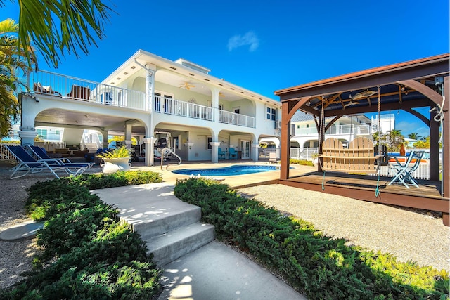 back of house featuring a patio area and a balcony