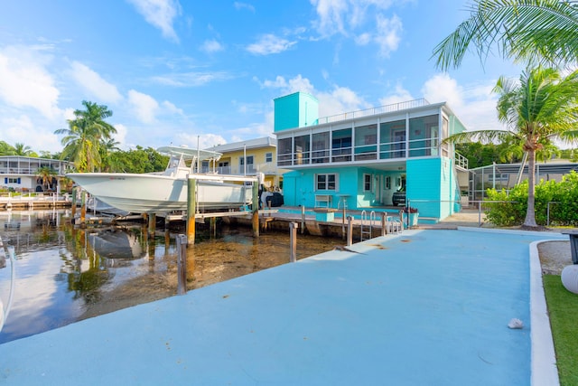 exterior space featuring a water view and a sunroom