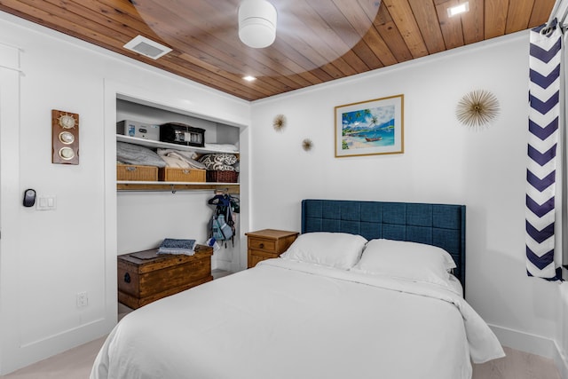 bedroom featuring wood ceiling and a closet