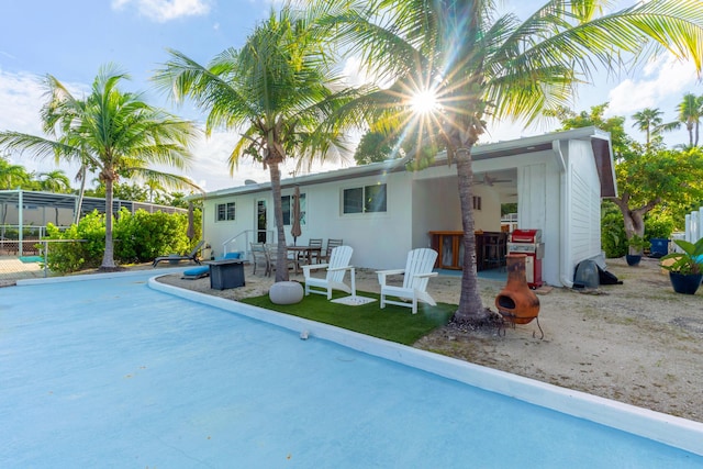 rear view of house featuring a lanai, a patio, and ceiling fan