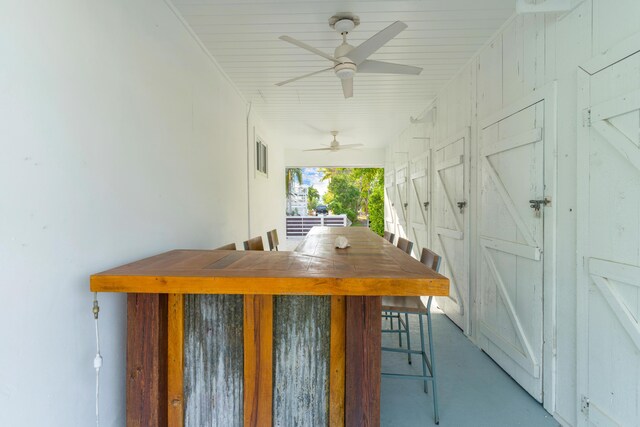 unfurnished dining area featuring concrete floors and ceiling fan