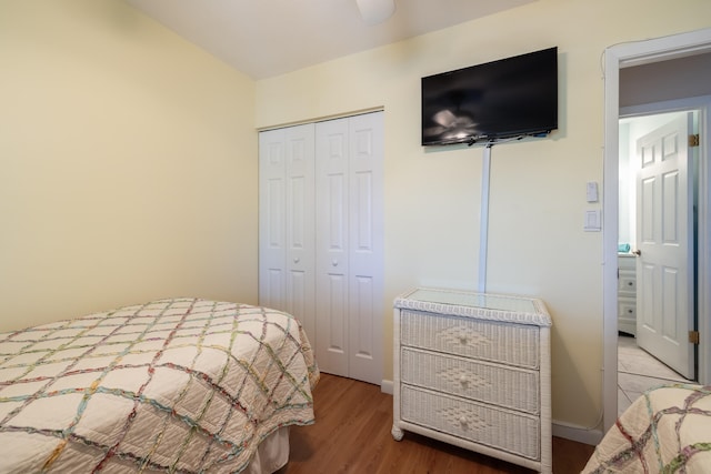 bedroom with wood-type flooring and a closet