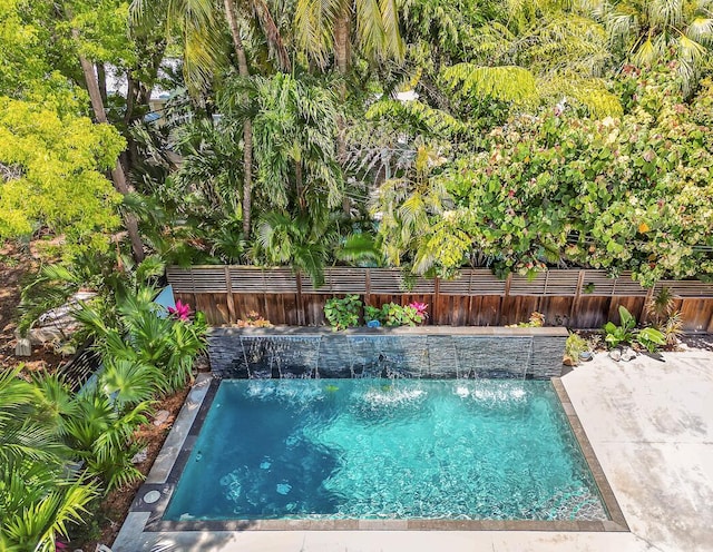 view of swimming pool with a fenced backyard and a fenced in pool