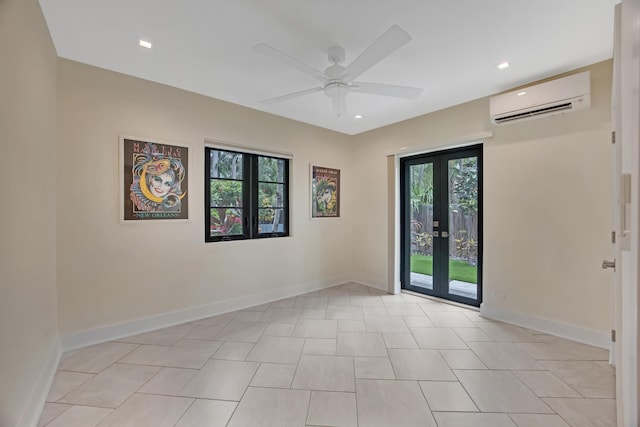 spare room featuring baseboards, plenty of natural light, a ceiling fan, and a wall mounted air conditioner