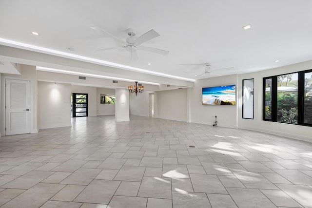 unfurnished room featuring baseboards, ceiling fan with notable chandelier, and recessed lighting