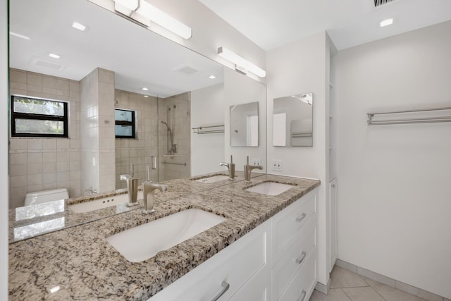 full bath featuring a sink, tile patterned flooring, and a stall shower