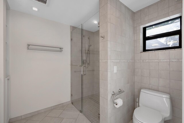full bath with tile patterned floors, a shower stall, toilet, and visible vents