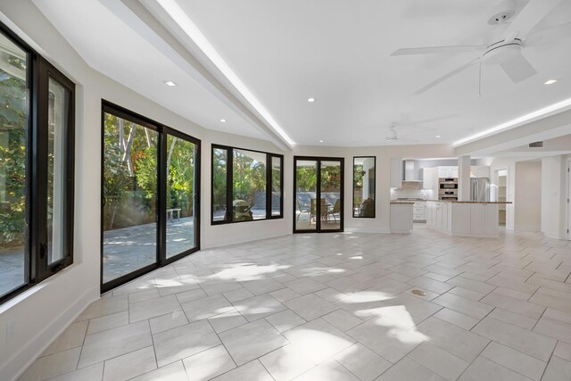 unfurnished living room featuring recessed lighting, a ceiling fan, baseboards, and light tile patterned floors