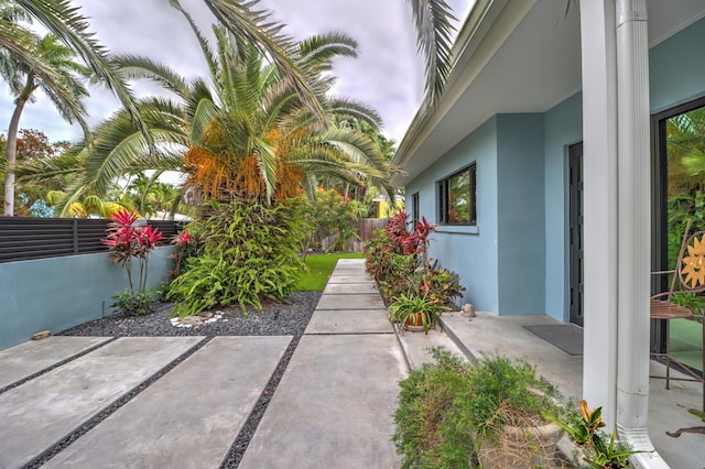 view of yard with fence and a patio