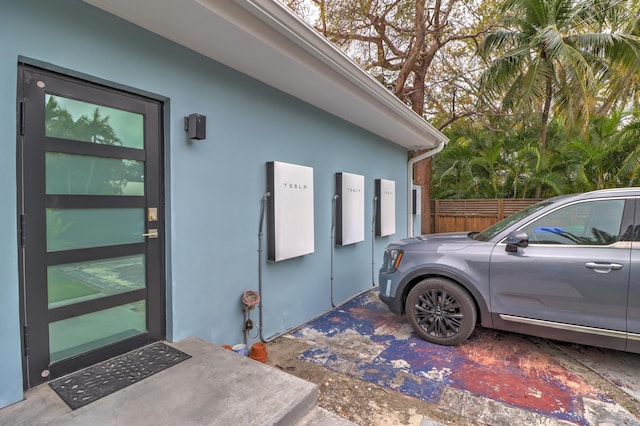 exterior space featuring stucco siding and fence