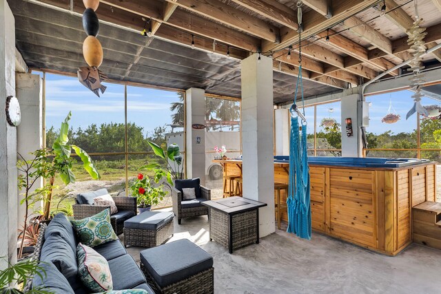 view of patio featuring outdoor lounge area, a hot tub, and outdoor dry bar