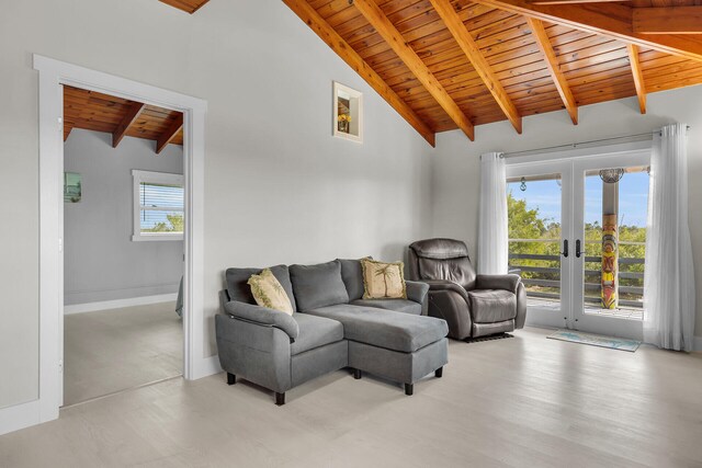 living room with french doors, wooden ceiling, beam ceiling, and a wealth of natural light