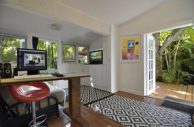 interior space featuring vaulted ceiling and plenty of natural light