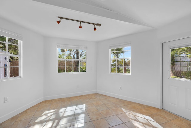 1513 5th St, Key West, FL 33040 - spare room with healthy amount of natural light, rail lighting, baseboards, and light tile patterned floors