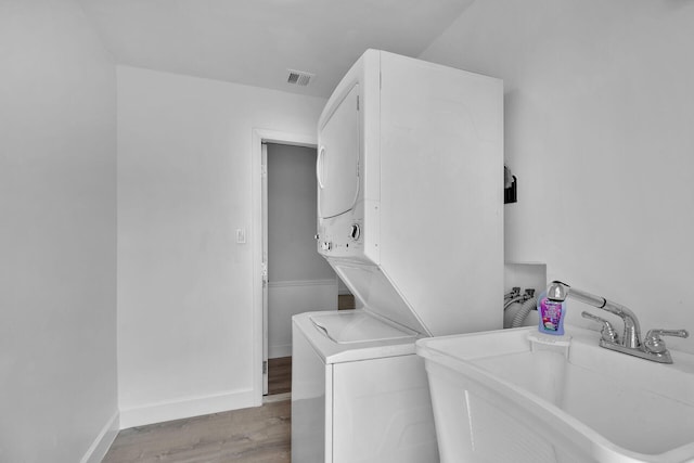 1513 5th St, Key West, FL 33040 - laundry area featuring stacked washer and clothes dryer, wood finished floors, and baseboards