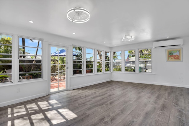 1513 5th St, Key West, FL 33040 - unfurnished sunroom featuring a wall unit AC, recessed lighting, baseboards, and wood finished floors