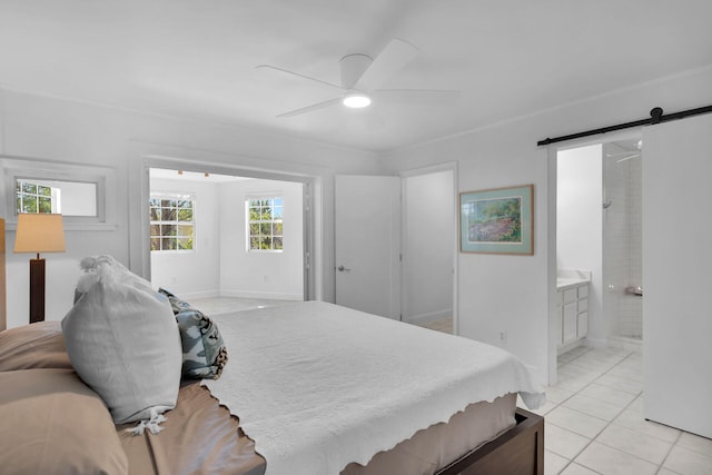 1513 5th St, Key West, FL 33040 - bedroom featuring a barn door, ceiling fan, baseboards, connected bathroom, and light tile patterned flooring