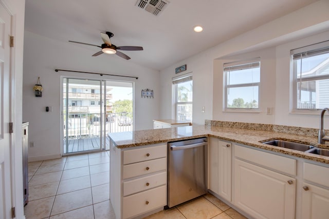 kitchen with sink, dishwasher, white cabinetry, light stone countertops, and kitchen peninsula