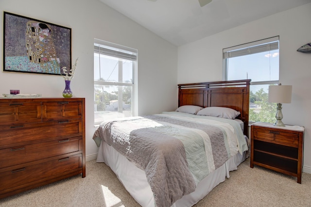 carpeted bedroom featuring vaulted ceiling and ceiling fan