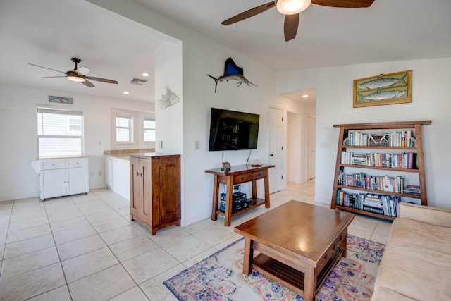 tiled living room with ceiling fan and vaulted ceiling