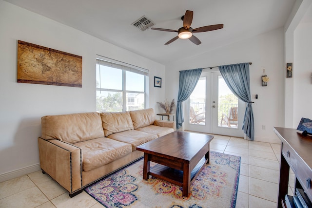 tiled living room with vaulted ceiling, french doors, and ceiling fan