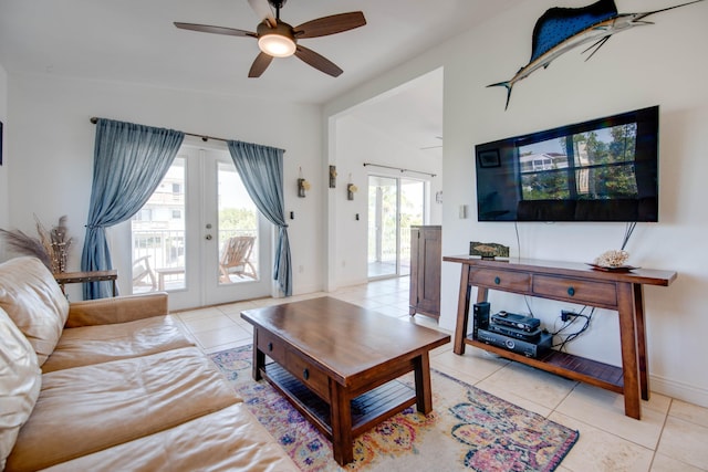 tiled living room with vaulted ceiling, french doors, and ceiling fan