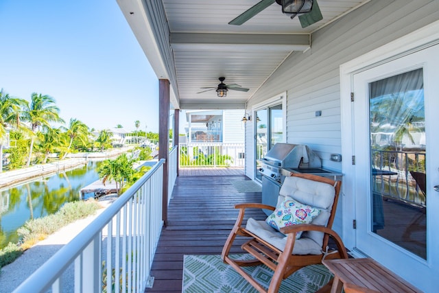 balcony featuring a water view, a grill, and ceiling fan