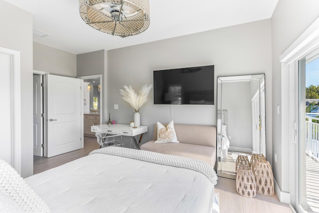 bedroom featuring access to exterior and hardwood / wood-style floors