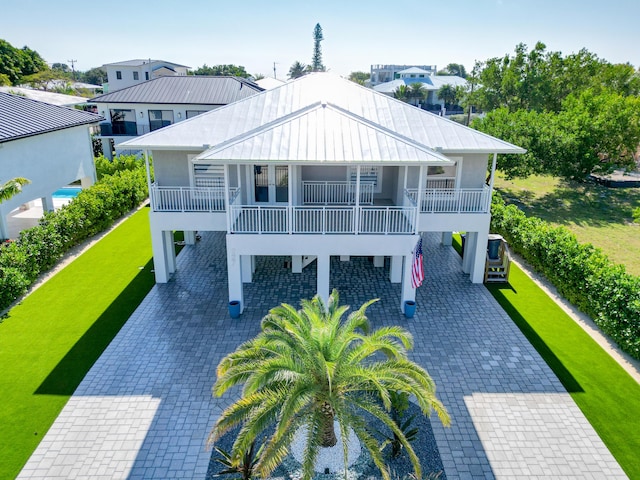 view of front of property with a carport and a balcony