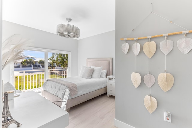 bedroom featuring access to outside and light hardwood / wood-style flooring