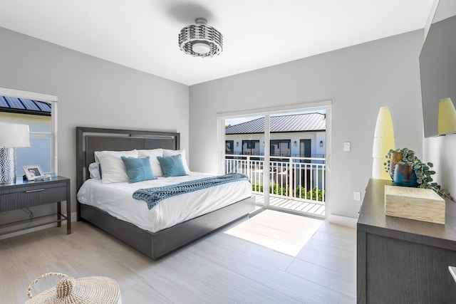 bedroom featuring light hardwood / wood-style flooring and access to outside