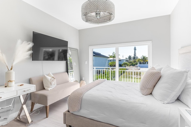 bedroom featuring light hardwood / wood-style floors and access to outside