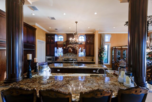 30 Cannon Royal Dr, Shark Key, FL 33040 - kitchen featuring visible vents, a sink, decorative columns, and stainless steel microwave