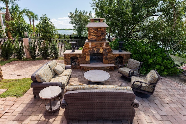 30 Cannon Royal Dr, Shark Key, FL 33040 - view of patio / terrace featuring a water view, fence, and an outdoor living space with a fireplace
