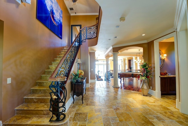 30 Cannon Royal Dr, Shark Key, FL 33040 - stairway with crown molding, arched walkways, baseboards, ornate columns, and stone tile floors