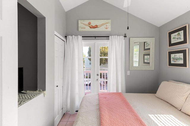 tiled bedroom featuring access to exterior, vaulted ceiling, and french doors