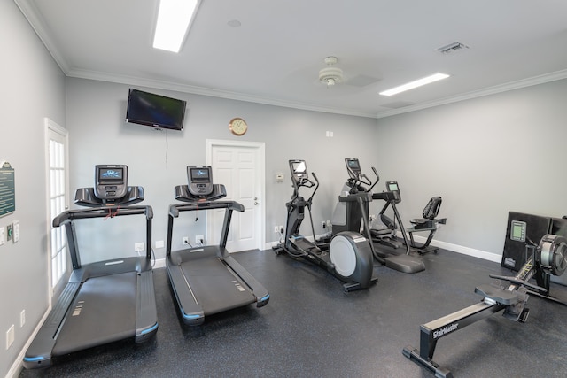 exercise room featuring plenty of natural light, visible vents, crown molding, and baseboards